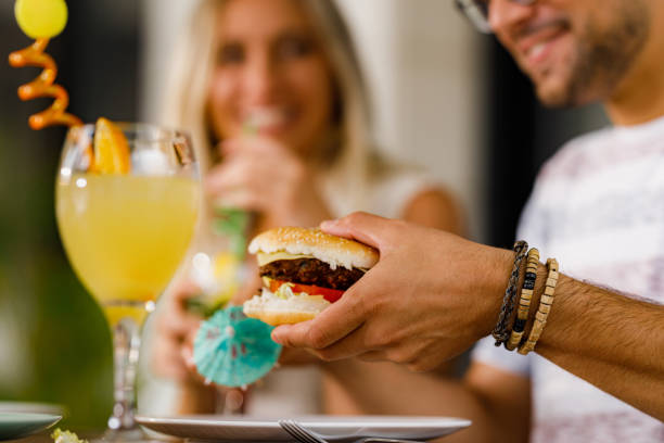 istock Close up of taking cheeseburger from a plate. 1390044555