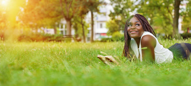 Pretty smiling young girl relaxing outdoor stock photo
