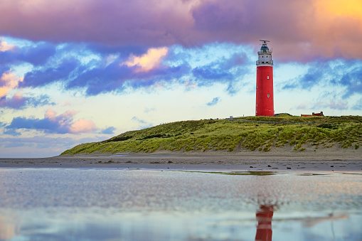 Lighthouse at the Wadden island Texel in the dunes during a stormy autumn evening. The Eierland lighthouse is located at the North point of the island.