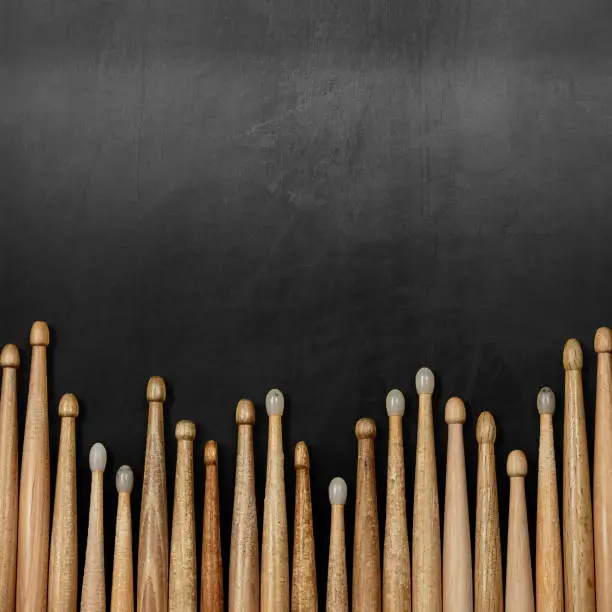 Photo of Group of Wooden Drumsticks on a Blackboard with Copy Space