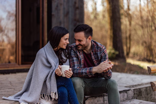 istock Lovely couple, looking at each other, drinking tea, enjoying outside. 1390048491