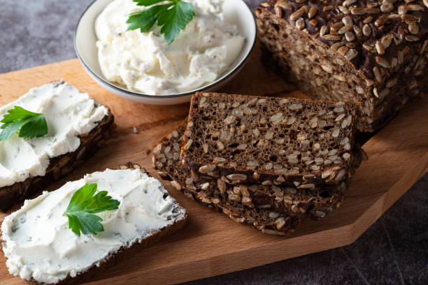istock Rye bread with cream cheese on grey table. Whole grain rye bread with seeds 1390050906