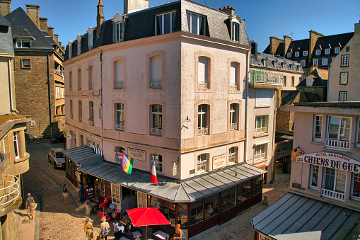 Saint-Malo, France, August 30, 2019: Summer day at the famous city of Saint-Malo. It is a historic French port in Ille-et-Vilaine, Brittany on the English Channel coast. The city had a long history of piracy, earning much wealth from local extortion and overseas adventures. The city changed into a popular tourist centre, with a ferry terminal serving the Channel Islands of Jersey and Guernsey, as well as the Southern English settlements of Portsmouth, Hampshire and Poole, Dorset.