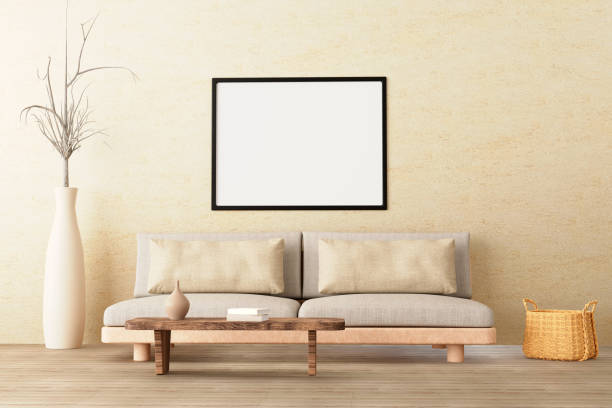 istock Horizontal poster mockup in neutral style interior living room with low sofa, ceramic jug, side table, wicker basket and books on empty concrete wall background. 3d illustration. 1390051220