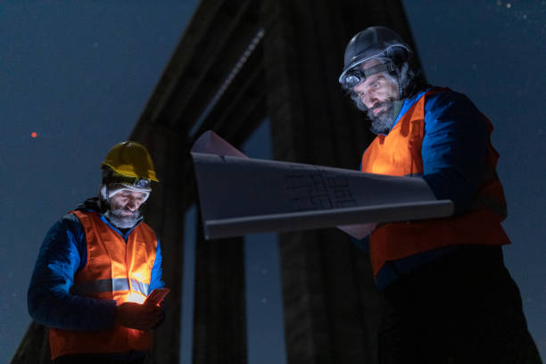 istock Road engineer working at night. Building new highways. 1390053563
