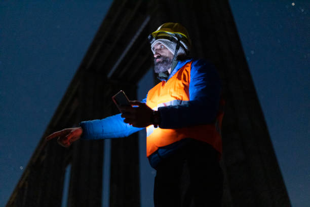 istock Road engineer working at night. Building new highways. 1390053567