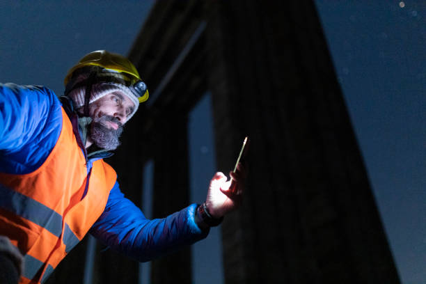 istock Road engineer working at night. Building new highways. 1390053569