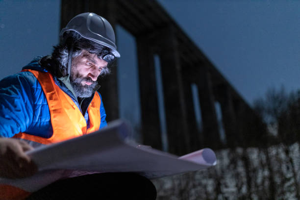 istock Road engineer working at night. Building new highways. 1390053579