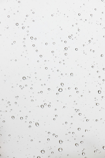 Close-up of water drops on silver surface, wet background