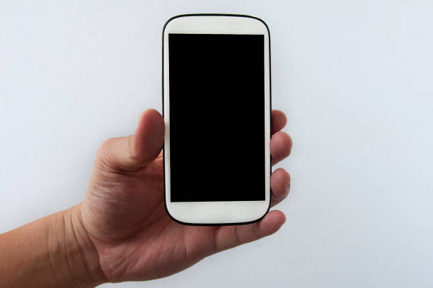 Hand holding white smartphone isolated on white background.