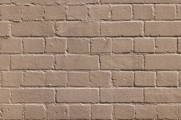 istock Part of a painted old beige brick wall 1390059994