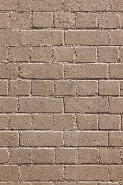 istock Part of a painted old beige brick wall 1390060010
