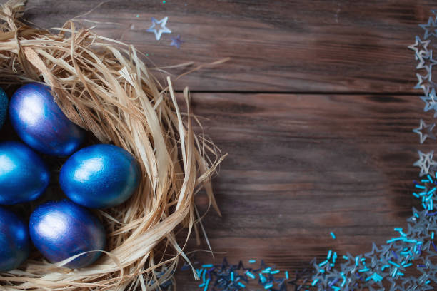 istock Blue Easter eggs in a nest on a wooden background. Easter card with a place to copy the text. The concept of bright Easter. 1390060011