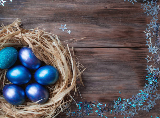 istock Blue Easter eggs in a nest on a wooden background. Easter card with a place to copy the text. The concept of bright Easter. 1390060014
