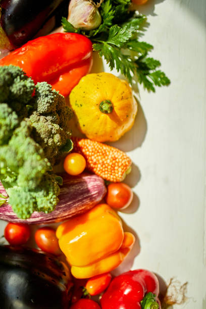istock Top view assorted fresh organic vegetables on table in the kitchen in sunlight, grocery healthy shopping, vegan foodÐ± flat lay, copy space. Layout with free text 1390060226