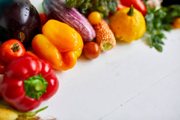 istock Top view assorted fresh organic vegetables on table in the kitchen in sunlight, grocery healthy shopping, vegan foodÐ± flat lay, copy space. Layout with free text 1390060228