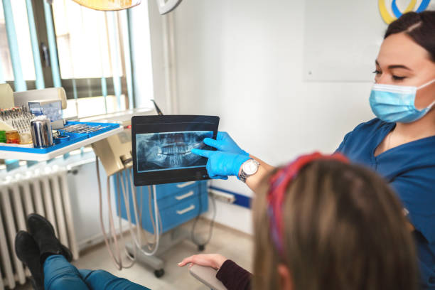 istock Young woman having her teeth checked during appointment at dentist's office 1390061915