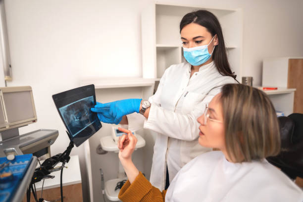 istock Young woman having her teeth checked during appointment at dentist's office 1390062196