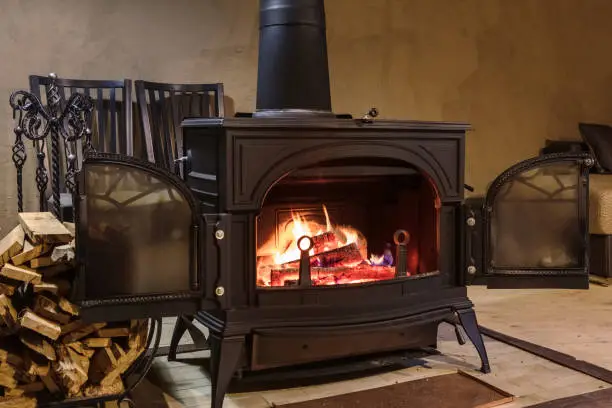 Photo of burning wood in the stove in a country house