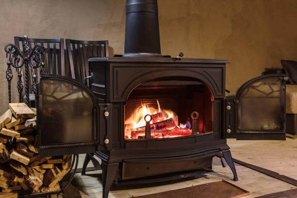 burning wood in the stove in a country house - cast in stone imagens e fotografias de stock