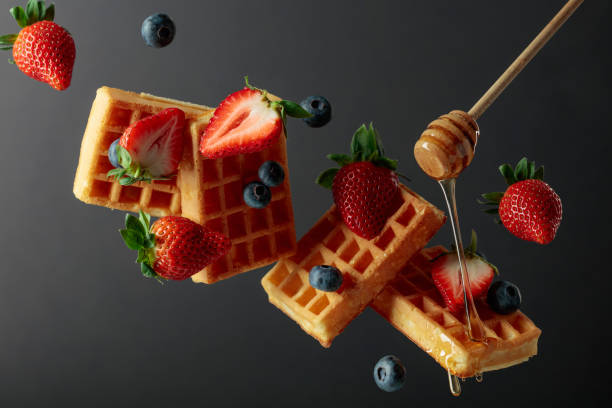 istock Waffles with blueberries, strawberries, and honey. 1390066304