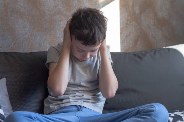 istock A boy clutched his head with his hands 1390068693