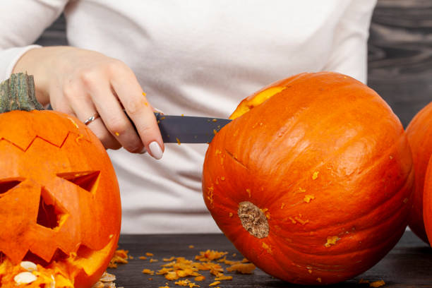 istock preparing an orange pumpkin for Halloween celebration 1390070249