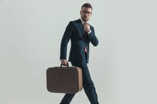 istock side view of bearded man with glasses adjusting tie and travelling 1390071128