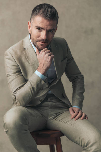 istock fashion model sitting on a chair, posing relaxed 1390071249