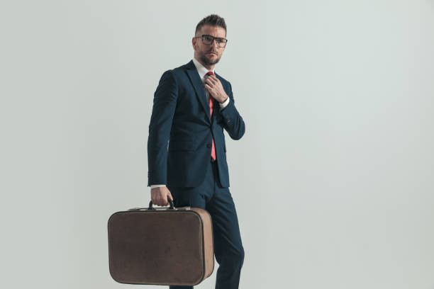 istock elegant businessman with baggage going to work conference 1390071514