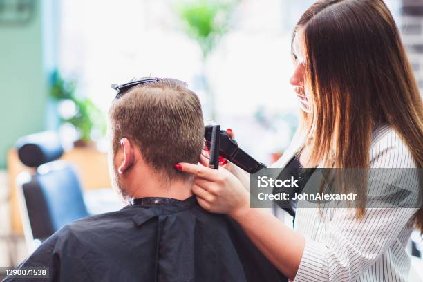 Hairdresser Woman Cutting A Mans Hair In A Barbershop Stock Photo - Download Image Now