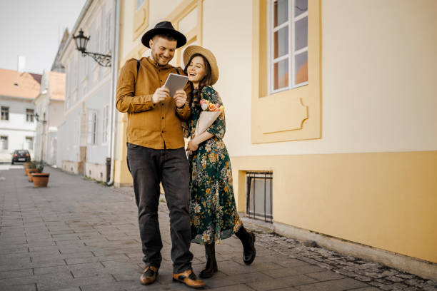istock Young Couple Using Digital Tablet On The Street 1390072308