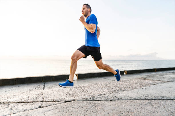 istock middle-aged male runner run on embankment 1390072390