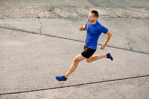 middle-aged male runner athlete run on road