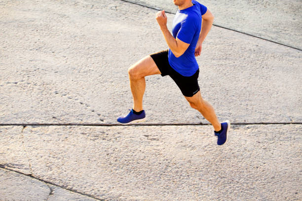 istock male runner athlete running overhead view 1390072403