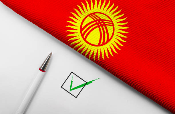Pencil, Flag of Kyrgyzstan and check mark on paper sheet