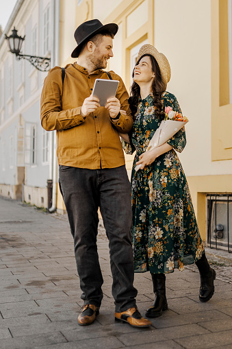 Young Couple Using Digital Tablet On The Street