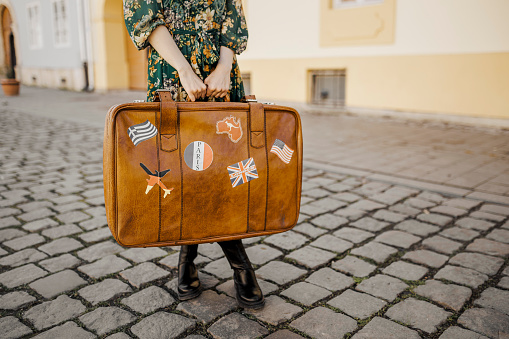 Close up of woman holding her luggage