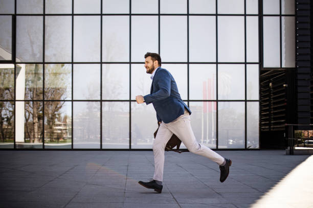 istock Young businessman getting late running to work 1390077346