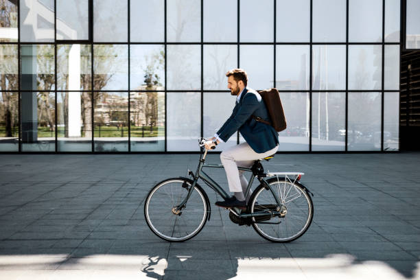 istock Businessman getting to work with bicycle 1390077350