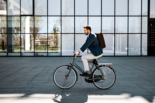 Casual business man getting to work with bicycle
