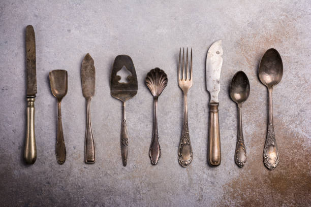 Vintage silverware, old tea spoons on white background. Table top view closeup