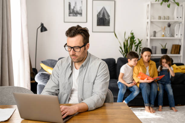istock Dad working on the distance in home office 1390080524