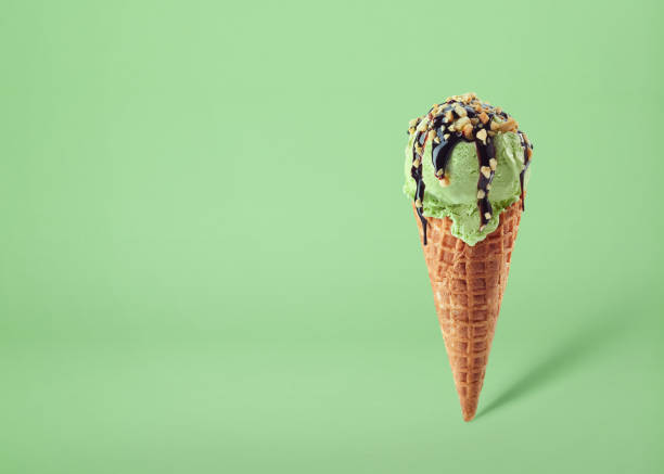istock Pistachio ice cream scoop in waffle cone 1390080570