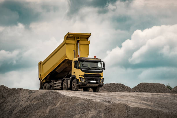 istock Construction site, yellow truck with raised body 1390081384