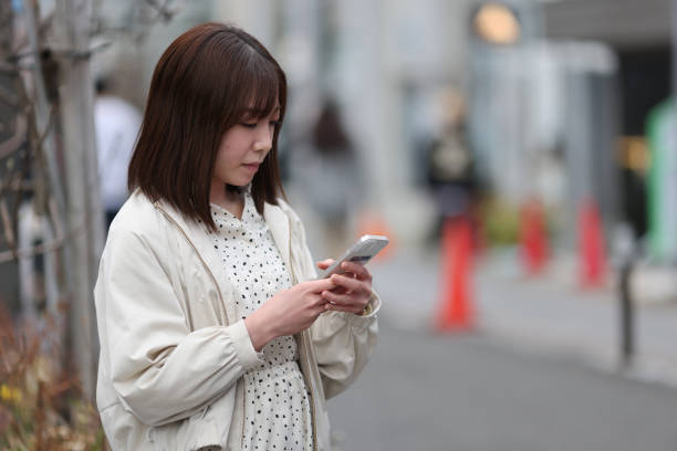 istock Beautiful young lady checking her mobile phone 1390081507