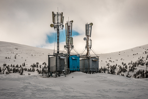 Antenna and Transceiver 5G, 4G on top of the mountains in winter with snow