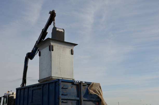 istock waste recycling in separated waste containers. the bottom lid opens when the crane is pulled over the body of the truck, the raw material is dumped into the sorted waste. underground metal container, 1390082442