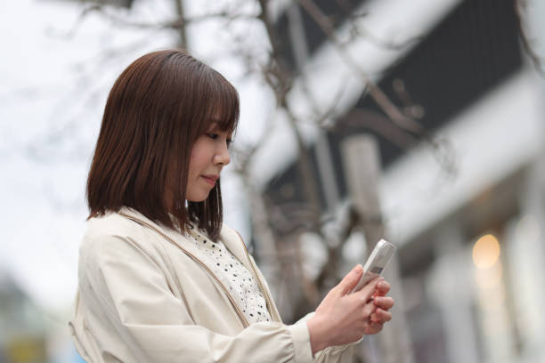 istock Beautiful young lady checking her mobile phone 1390082698