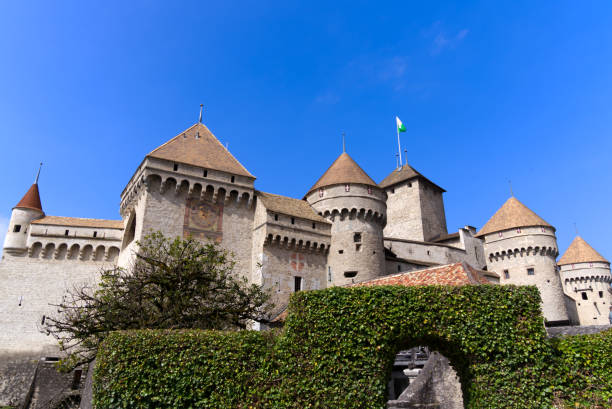 Beautiful medieval Château de Chillon at Canton Vaud, Switzerland. Famous Chillon Castle at border of Lake Geneva on a blue cloudy spring day. Photo taken April 4th, 2022, Veytauy-Chillon, Switzerland. chateau de chillon stock pictures, royalty-free photos & images